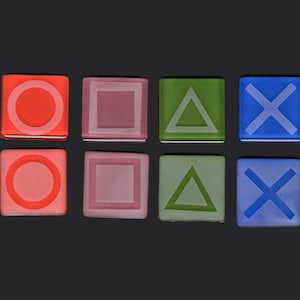 May include: Eight square tiles with different colored backgrounds and white symbols. The symbols are a circle, a square, a triangle, and an X. The tiles are arranged in two rows of four.