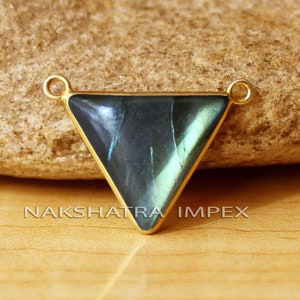 May include: Gold-tone pendant with a triangular labradorite gemstone. The pendant has two loops at the top for attaching a chain.