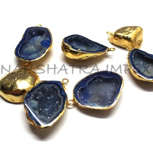 May include: Six gold-plated agate gemstone pendants with blue and white crystal formations. The pendants have a teardrop shape and are perfect for jewelry making.