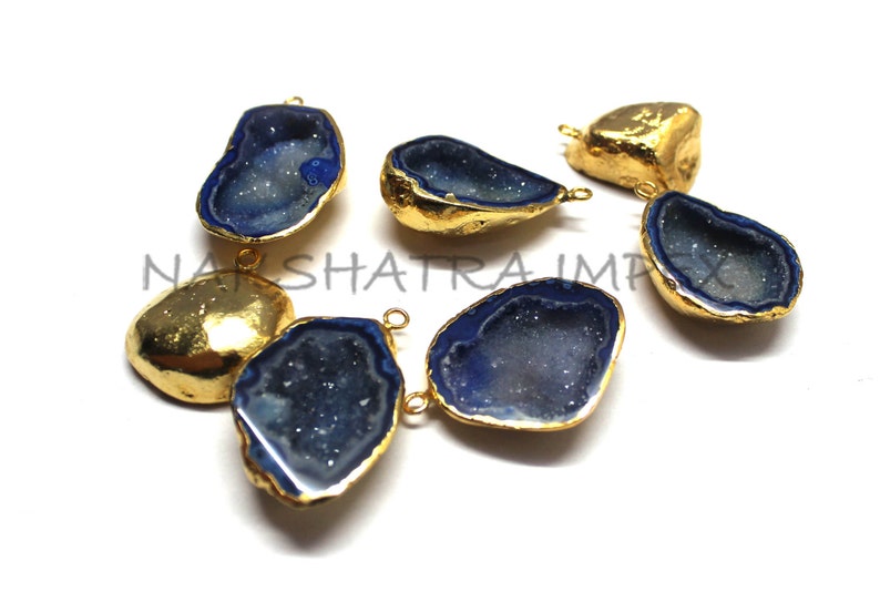 May include: Six gold-plated agate gemstone pendants with blue and white crystal formations. The pendants have a teardrop shape and are perfect for jewelry making.