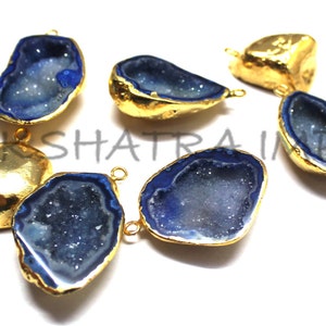 May include: Six gold-plated agate gemstone pendants with blue interiors. The pendants have a raw, natural look and are perfect for jewelry making.