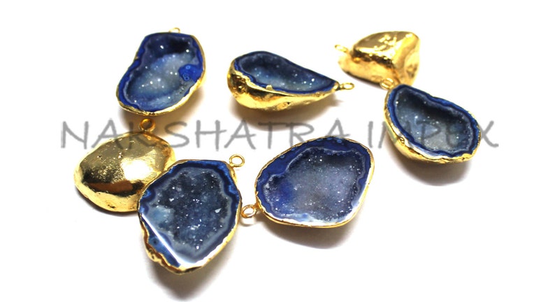 May include: Six gold-plated agate gemstone pendants with blue interiors. The pendants have a raw, natural look and are perfect for jewelry making.