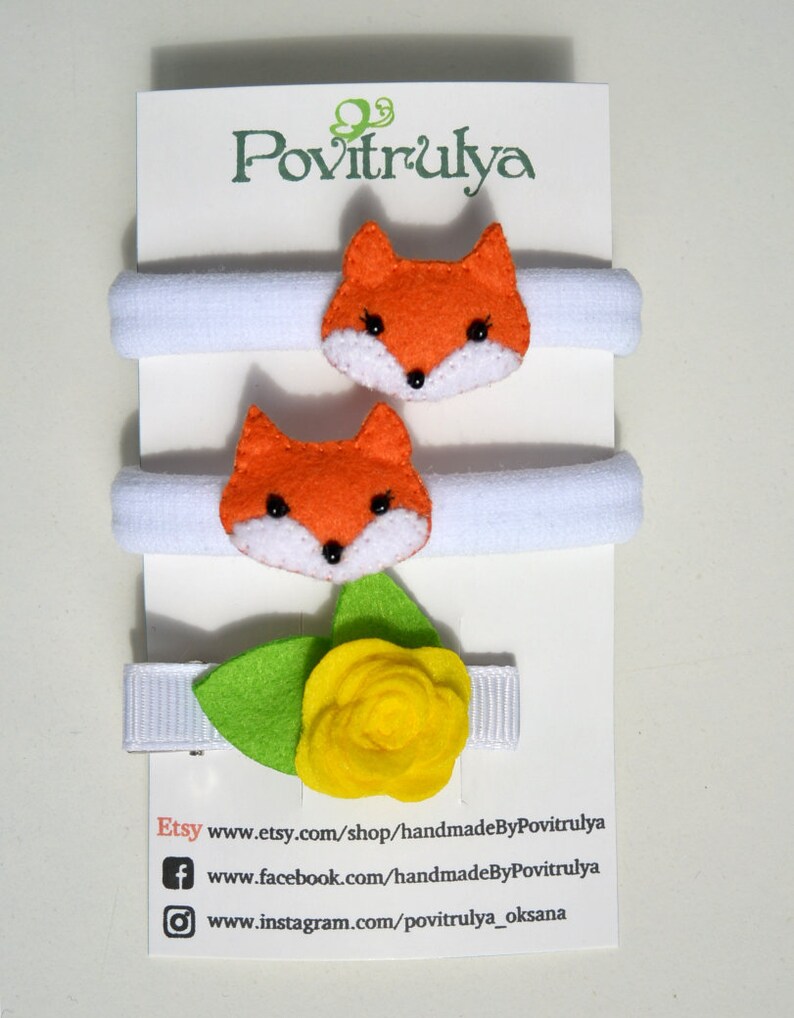May include: Set of two white hair ties with orange felt fox head embellishments and a white hair clip with a yellow felt flower and green felt leaves. Etsy: www.etsy.com/shop/handmadeByPovitrulya Facebook: www.facebook.com/handmadeByPovitrulya Instagram: www.instagram.com/povitrulya_oksana