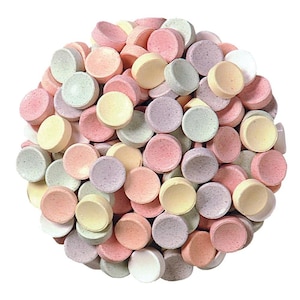 May include: A pile of pastel-colored, round candies. The candies are in shades of pink, yellow, green, and purple. The candies are arranged in a circular shape against a white background.