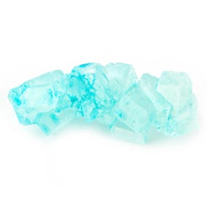May include: A close-up of a pile of light blue rock candy. The candy is translucent and has a slightly irregular shape.