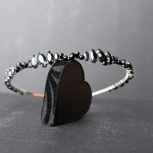 Black Wedding Hair Accessory, inspired by the desire to be different. Stand out with your own unique style on your special day with this black headband. A handmade gothic bride hair piece, black bridal or bridesmaid tiara headband, lovely for a gothic themed wedding.  

A silver toned tiara band hand wound with silver toned wire and black glass beads (6 and 4 mm) and black horse eye diamante rhinestones (15, 12 and 8 mm) for the ultimate goth bride or bridesmaid.
