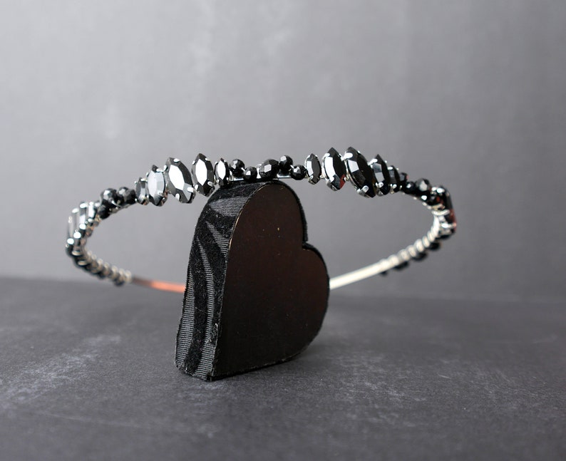 Black Wedding Hair Accessory, inspired by the desire to be different. Stand out with your own unique style on your special day with this black headband. A handmade gothic bride hair piece, black bridal or bridesmaid tiara headband, lovely for a gothic themed wedding.  

A silver toned tiara band hand wound with silver toned wire and black glass beads (6 and 4 mm) and black horse eye diamante rhinestones (15, 12 and 8 mm) for the ultimate goth bride or bridesmaid.