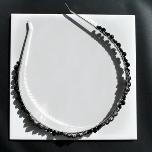 Black Wedding Hair Accessory, inspired by the desire to be different. Stand out with your own unique style on your special day with this black headband. A handmade gothic bride hair piece, black bridal or bridesmaid tiara headband, lovely for a gothic themed wedding.  

A silver toned tiara band hand wound with silver toned wire and black glass beads (6 and 4 mm) and black horse eye diamante rhinestones (15, 12 and 8 mm) for the ultimate goth bride or bridesmaid.