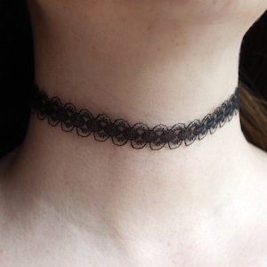 May include: A black lace choker necklace.