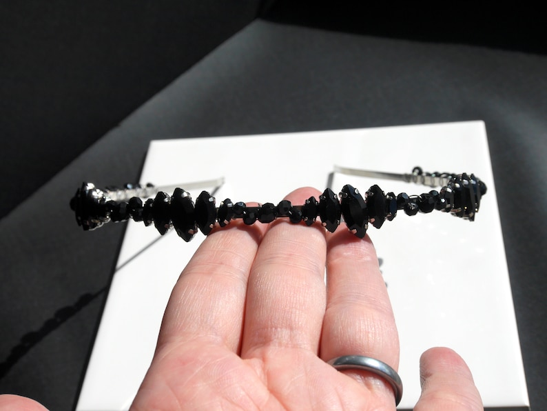 Black Wedding Hair Accessory, inspired by the desire to be different. Stand out with your own unique style on your special day with this black headband. A handmade gothic bride hair piece, black bridal or bridesmaid tiara headband, lovely for a gothic themed wedding.  

A silver toned tiara band hand wound with silver toned wire and black glass beads (6 and 4 mm) and black horse eye diamante rhinestones (15, 12 and 8 mm) for the ultimate goth bride or bridesmaid.