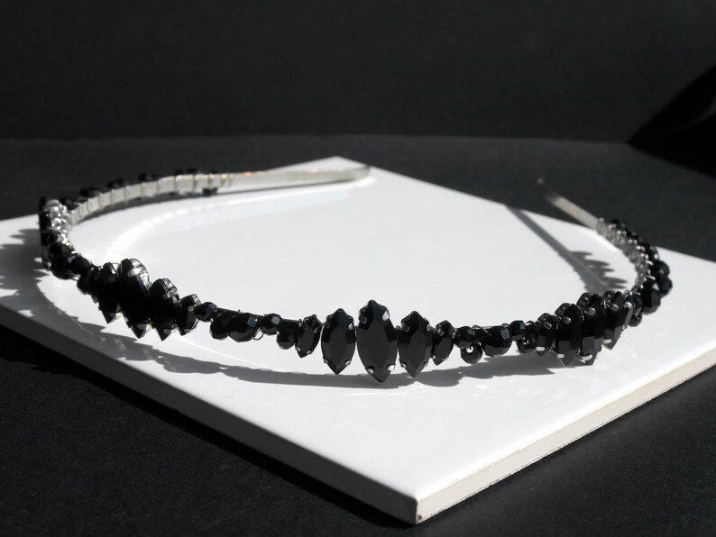 Black Wedding Hair Accessory, inspired by the desire to be different. Stand out with your own unique style on your special day with this black headband. A handmade gothic bride hair piece, black bridal or bridesmaid tiara headband, lovely for a gothic themed wedding.  

A silver toned tiara band hand wound with silver toned wire and black glass beads (6 and 4 mm) and black horse eye diamante rhinestones (15, 12 and 8 mm) for the ultimate goth bride or bridesmaid.