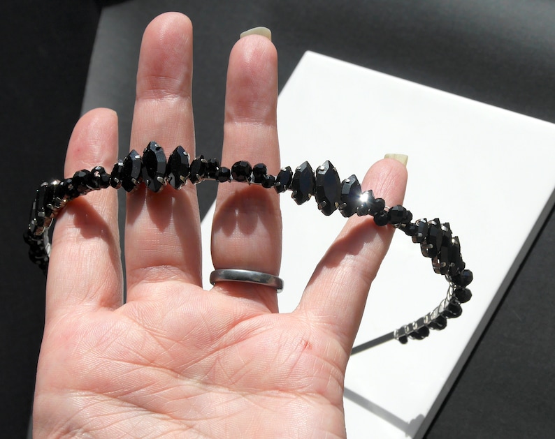 Black Wedding Hair Accessory, inspired by the desire to be different. Stand out with your own unique style on your special day with this black headband. A handmade gothic bride hair piece, black bridal or bridesmaid tiara headband, lovely for a gothic themed wedding.  

A silver toned tiara band hand wound with silver toned wire and black glass beads (6 and 4 mm) and black horse eye diamante rhinestones (15, 12 and 8 mm) for the ultimate goth bride or bridesmaid.