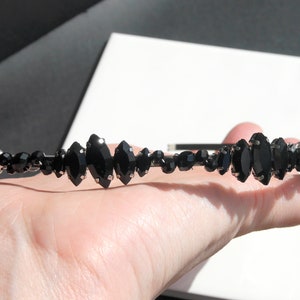 Black Wedding Hair Accessory, inspired by the desire to be different. Stand out with your own unique style on your special day with this black headband. A handmade gothic bride hair piece, black bridal or bridesmaid tiara headband, lovely for a gothic themed wedding.  

A silver toned tiara band hand wound with silver toned wire and black glass beads (6 and 4 mm) and black horse eye diamante rhinestones (15, 12 and 8 mm) for the ultimate goth bride or bridesmaid.