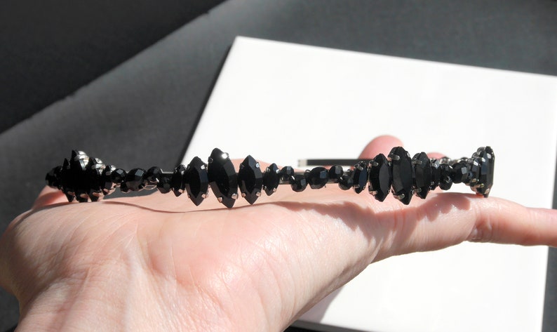 Black Wedding Hair Accessory, inspired by the desire to be different. Stand out with your own unique style on your special day with this black headband. A handmade gothic bride hair piece, black bridal or bridesmaid tiara headband, lovely for a gothic themed wedding.  

A silver toned tiara band hand wound with silver toned wire and black glass beads (6 and 4 mm) and black horse eye diamante rhinestones (15, 12 and 8 mm) for the ultimate goth bride or bridesmaid.