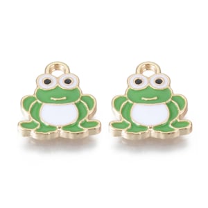 May include: Two gold-coloured frog charms with green and white enamel. The frogs have black eyes and a small loop at the top for attaching to jewellery.