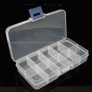 May include: A clear plastic storage box with a blue latch. The box has 10 compartments for organising small items.