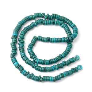 May include: A strand of teal blue round wooden beads. The beads are stacked on top of each other, creating a layered effect.