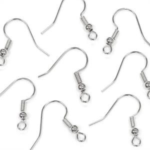 May include: A collection of silver-colored earring hooks, displayed against a white background. Each hook features a curved wire design with a coil and a small bead, and a loop at the bottom for attaching earrings. The hooks are designed for jewelry making.