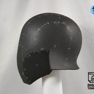 May include: A black foam helmet with white markings and numbers. The helmet is designed for cosplay or prop making.