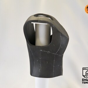May include: A black foam vest with markings for sewing, displayed on a white mannequin form.