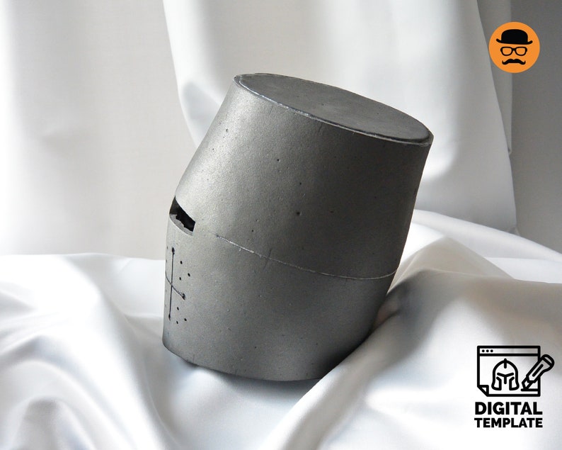 May include: A gray, cylindrical helmet with a cross design and eye slit. The helmet is angled and appears to be made of a textured material. The words "DIGITAL TEMPLATE" are visible in the lower right corner.