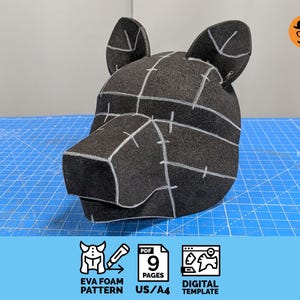 May include: A black EVA foam animal head mask pattern featuring white assembly lines and markings. The design includes two pointed ears and a snout. Below the mask, icons indicate a 9-page PDF digital template for EVA foam construction.