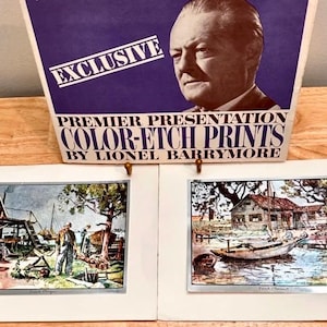 May include: A vintage print advertisement with the text "EXCLUSIVE" and "PREMIER PRESENTATION COLOR-ETCH PRINTS BY LIONEL BARRYMORE." Two framed color etch prints are displayed below the advertisement, each depicting a waterfront scene.