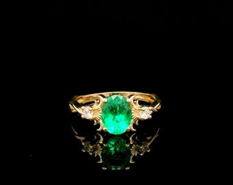 Anillo de oro amarillo de 9 quilates con diseño de esmeralda cultivada en laboratorio y montura retorcida.
