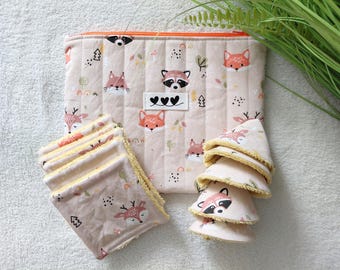 May include: A quilted fabric pouch with an orange zipper featuring a repeating pattern of foxes, raccoons, and deer on a light beige background. Included are several square and round fabric pads with yellow trim, matching the pouch's woodland print.