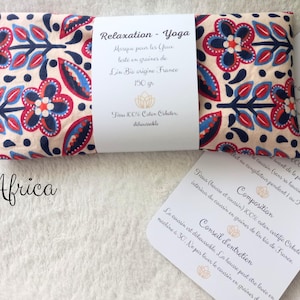 May include: A rectangular eye pillow with a cream background and a repeating floral pattern in navy blue, red, and light blue. A white paper band wraps around the center with the text Relaxation - Yoga, 150 gr, and Tissu 100% Coton Oeko-tex.