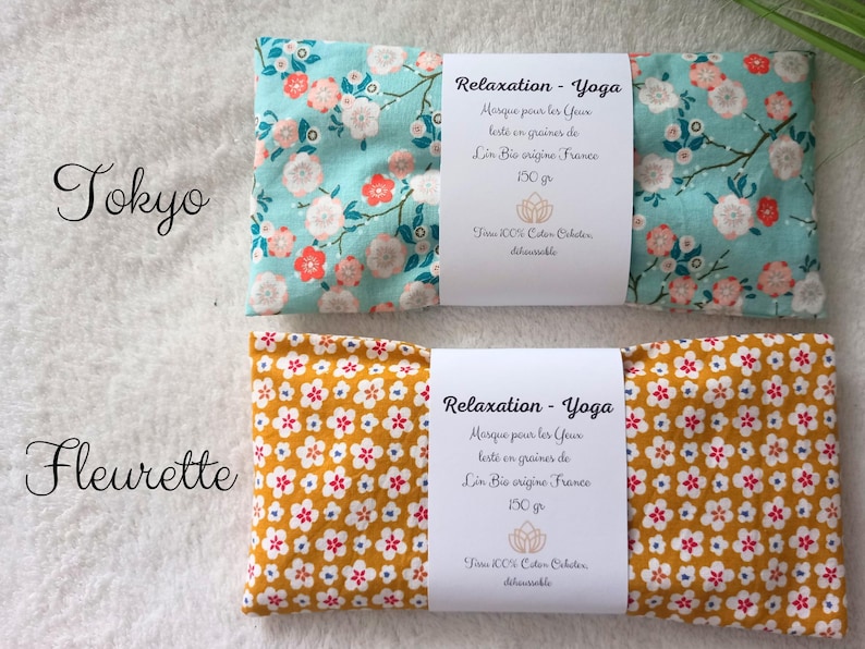 May include: Two rectangular eye pillows with fabric covers. The top pillow is light blue with a pink and white floral pattern labeled Tokyo. The bottom pillow is mustard yellow with a small white and red floral pattern labeled Fleurette.