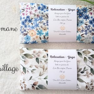 May include: Two rectangular eye pillows with white fabric bands. The top pillow features a blue and peach floral pattern labeled Romane. The bottom pillow features a green and brown leaf pattern labeled Feuillage. Both bands state Relaxation - Yoga.