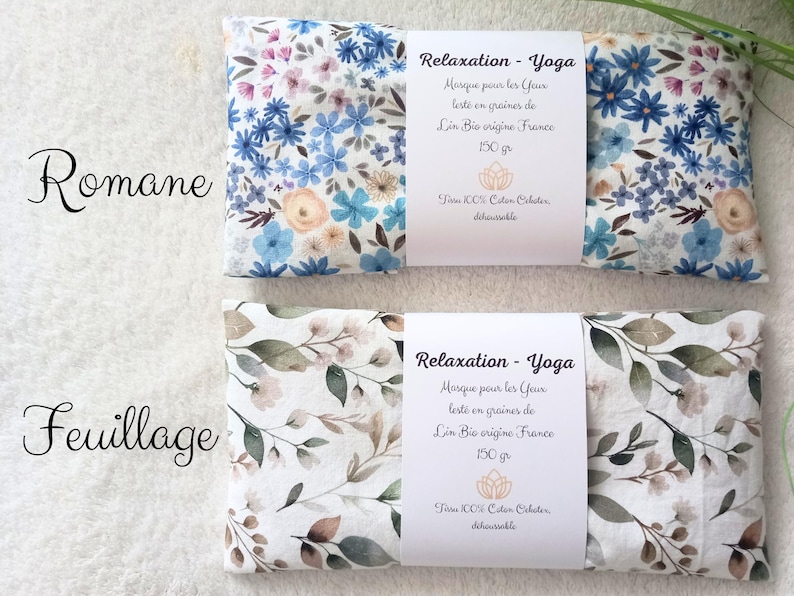 May include: Two rectangular eye pillows with white fabric bands. The top pillow features a blue and peach floral pattern labeled Romane. The bottom pillow features a green and brown leaf pattern labeled Feuillage. Both bands state Relaxation - Yoga.