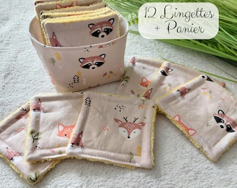 May include: A set of 12 square fabric wipes and a matching storage basket, all featuring a light pink background with a repeating pattern of woodland animals including raccoons, foxes, and deer, with yellow textured trim and edges.