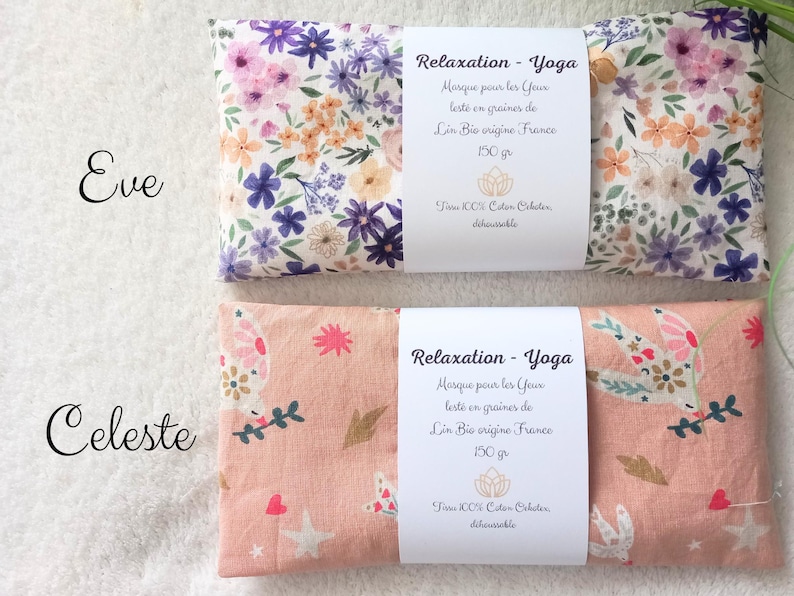 May include: Two rectangular eye pillows labeled Eve and Celeste. The Eve pillow features a white fabric with purple, pink, and orange floral patterns. The Celeste pillow is peach-colored with white bird, star, and heart motifs. Both have white paper bands.