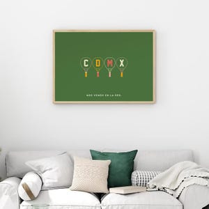 May include: A framed print with a green background features the letters "CDMX" in a playful font, each letter designed as a tennis racket. Below the letters, the text "NOS VEMOS EN LA RED" is displayed. The frame is a light wood color.