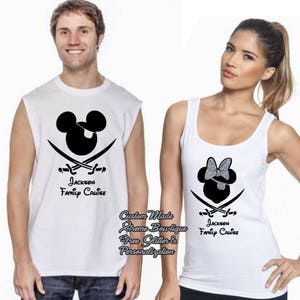 May include: White sleeveless shirts with black graphics. One shirt features a Mickey Mouse head with crossed swords, the other a Minnie Mouse head with a bow, and the text "Jackson Family Cruise".