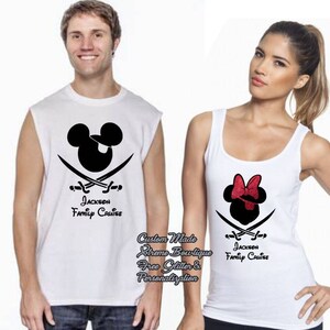 May include: White tank tops with black pirate-themed Mickey and Minnie Mouse designs. The Mickey Mouse design includes a pirate hat and crossed swords, while Minnie Mouse has a red bow. The text "Jackson Family Cruise" is printed below.