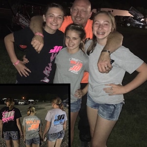 May include: A group of four people wearing racing shirts with the number 10 and the name "Willis" on them. The shirts are gray, black, and white. The people are standing in front of a dark background.
