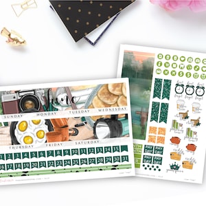 May include: A June calendar planner with a camping theme. The planner features illustrations of a camera, eggs, a guitar, a flashlight, and pancakes. The planner has green, black, and white accents.