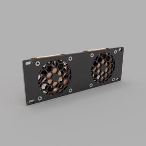 May include: A black computer fan with two circular vents featuring a honeycomb pattern. The fan has a rectangular frame with copper-colored accents and is secured with screws.