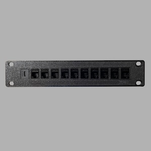 May include: Black plastic wall plate with 12 RJ-45 ports for ethernet connections.