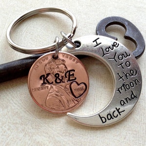 May include: A personalized keychain featuring a copper penny with initials "K&E" and a heart with "2016" engraved. A silver crescent moon charm reads "I Love You to the moon and back". Includes a key ring.