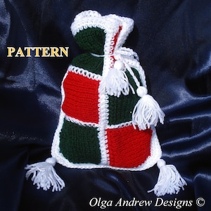 May include: A crocheted Christmas stocking with red, green, and white squares. The stocking has white tassels and a white crocheted border.