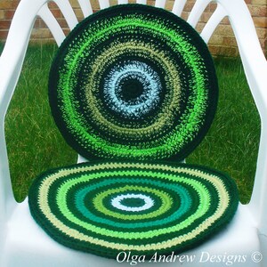 May include: Two crocheted round chair cushions in shades of green, beige, and white. The cushions have a concentric circle pattern.