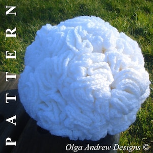 May include: A white crocheted brain-shaped object. The object is made with a thick yarn and has a textured surface.