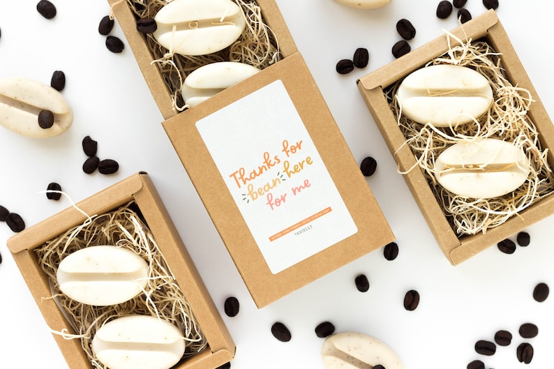 May include: A set of three brown boxes filled with coffee bean shaped soaps. Each box has a label that says "Thanks for bean-ing here for me".