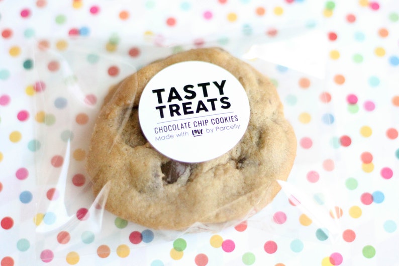 May include: A single chocolate chip cookie in a clear plastic bag with a white circle sticker that says "Tasty Treats Chocolate Chip Cookies Made with LOVE by Parcelly"