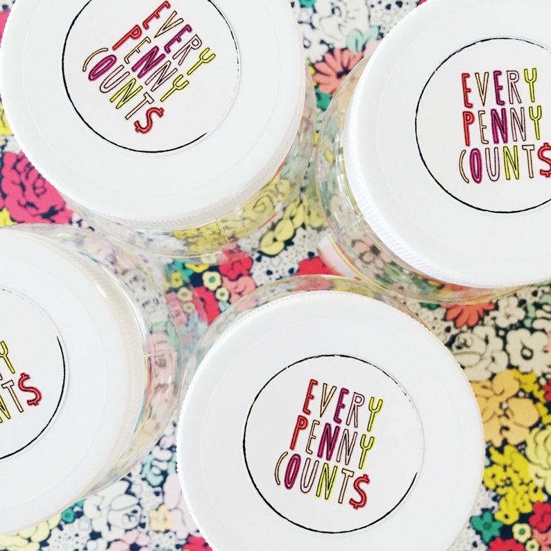 May include: Four clear glass jars with white lids. Each lid has a colorful sticker with the text "EVERY PENNY COUNTS" in a circle.