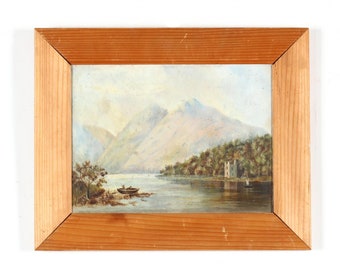 May include: A framed watercolor painting depicting a lake scene with mountains in the background. The lake is surrounded by trees and a small stone building. A boat with two people is in the foreground.